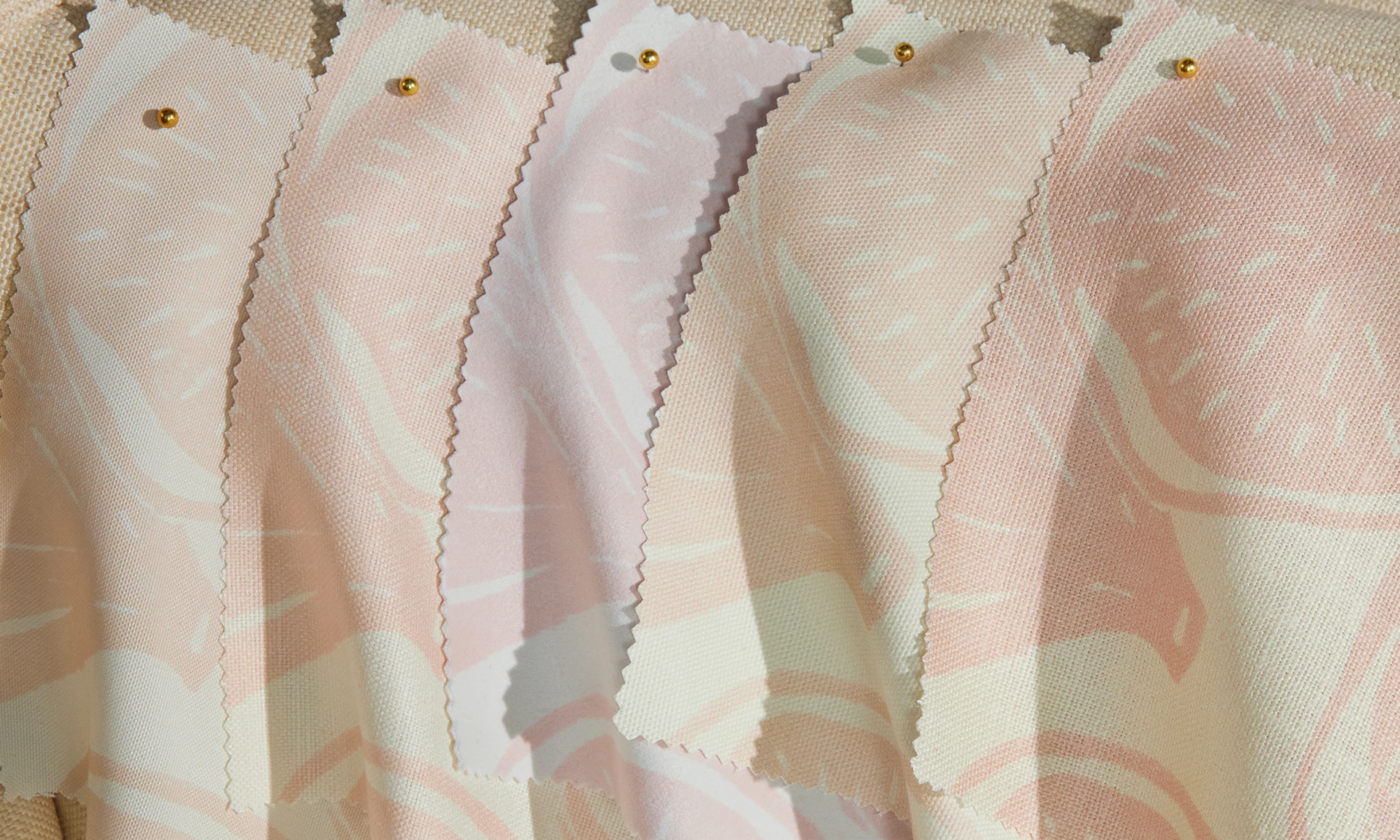 A selection of elegant fabrics pinned to a settee