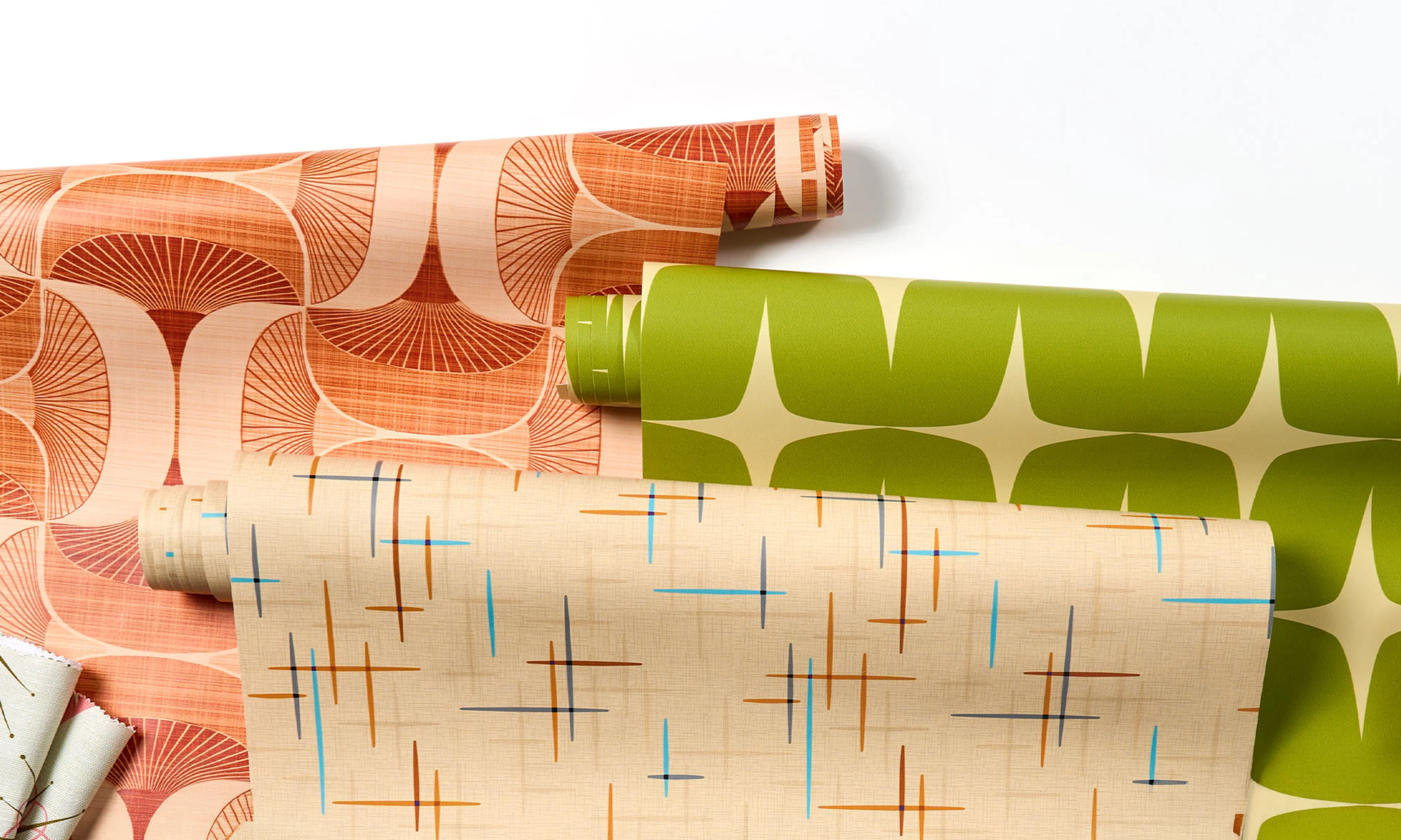An assortment of bright midcentury wallpaper rolls
