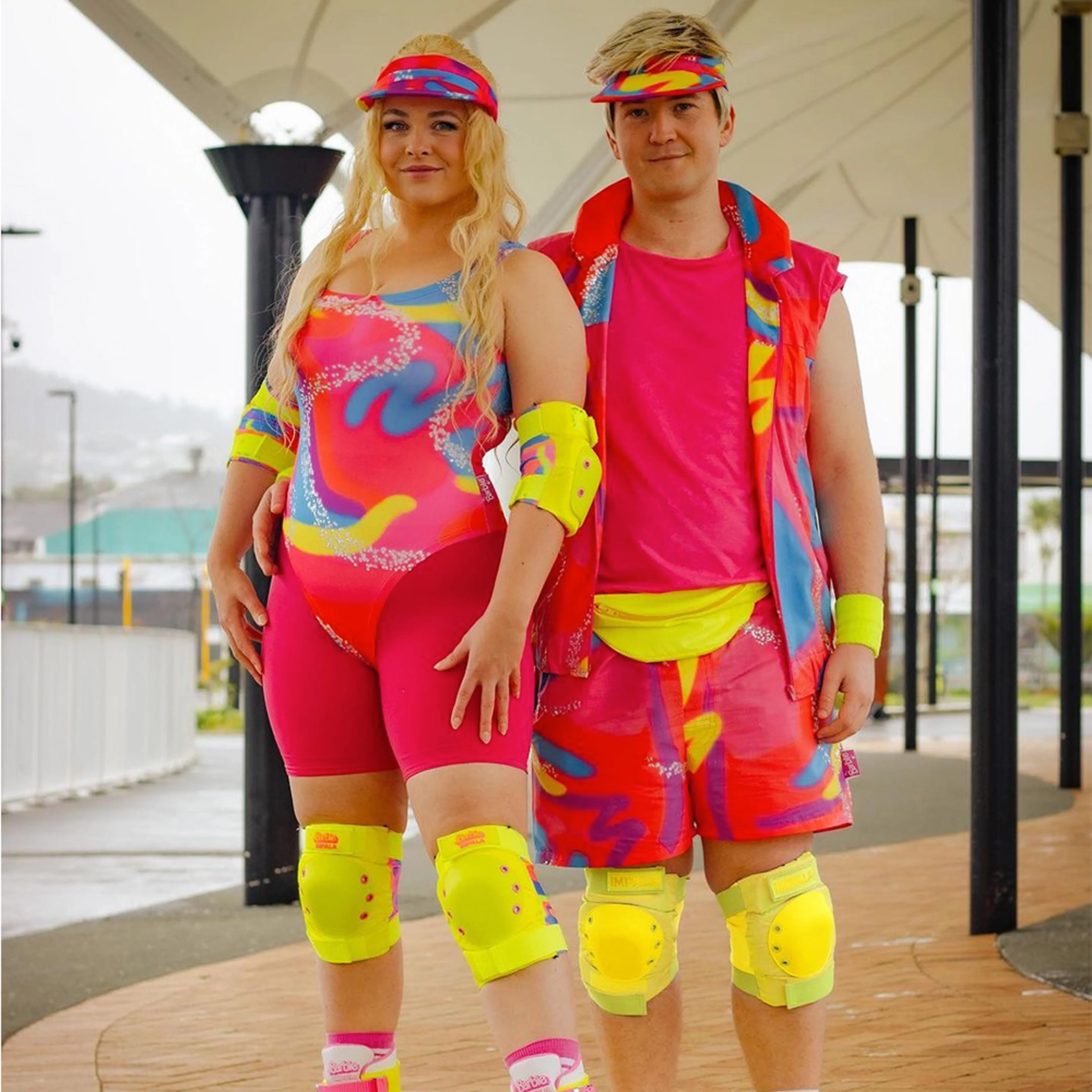 People dressed up as roller skating Barbie and Ken.