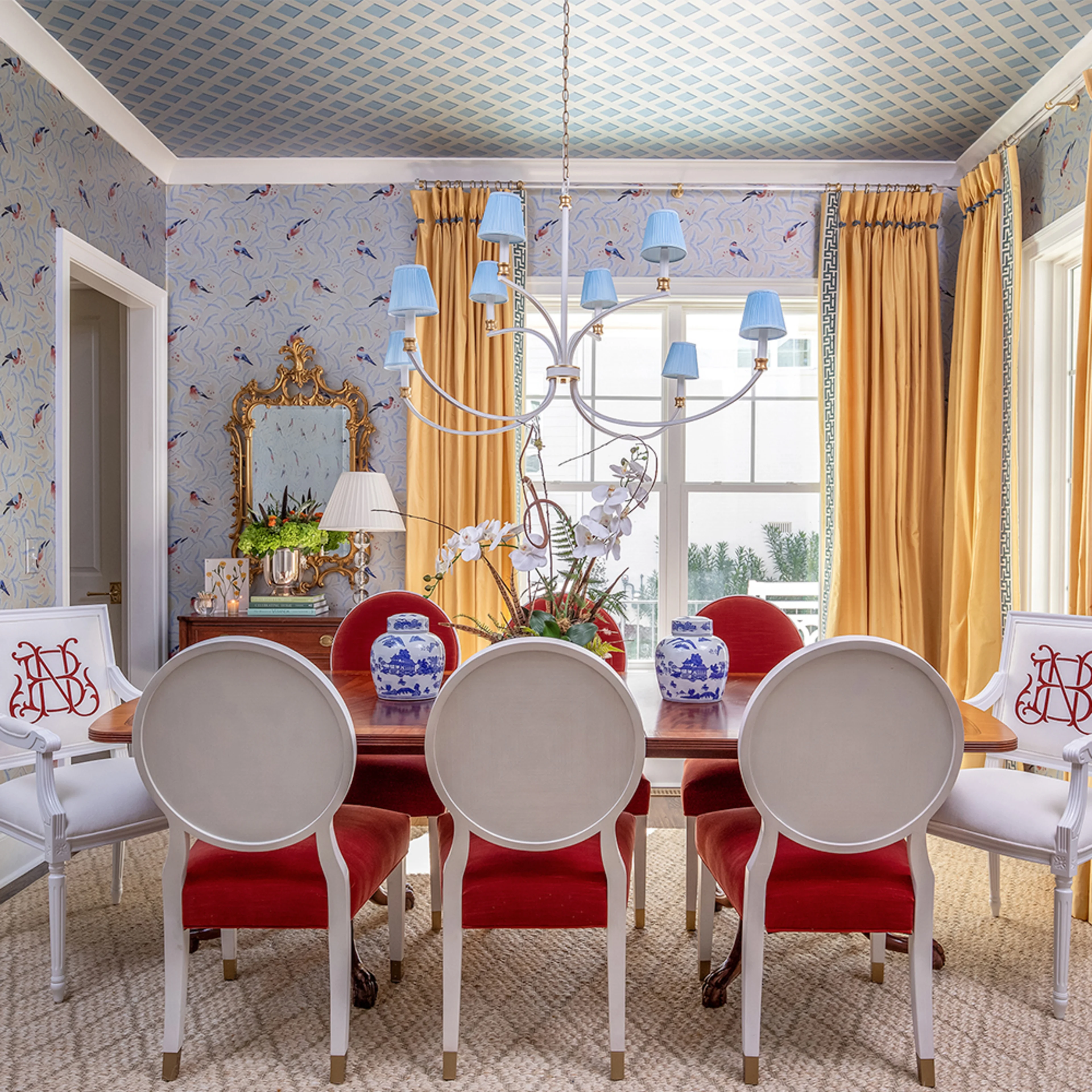 Dining room with silver metallic bird and trellis wallpaper.