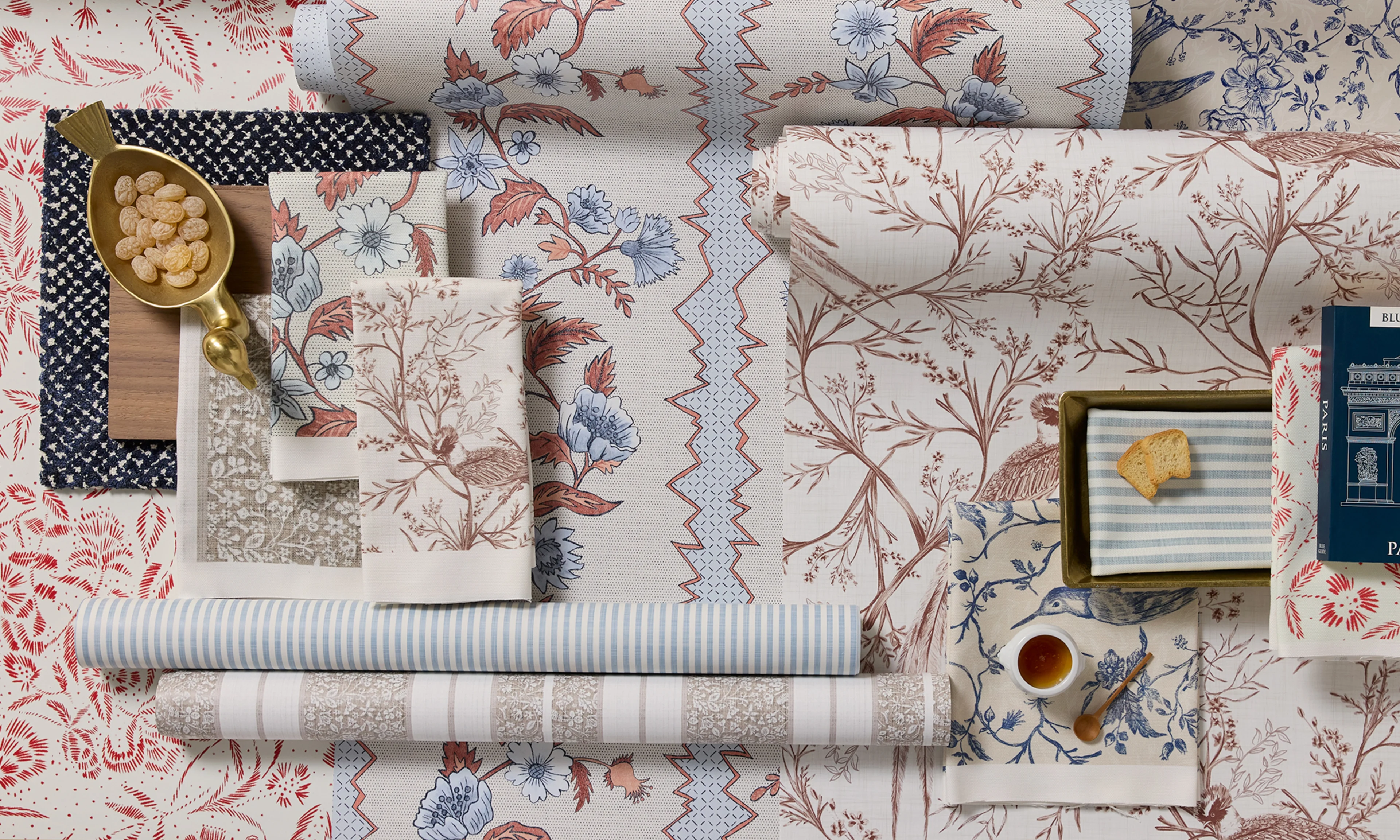 French country wallpaper rolls and fabric swatches.