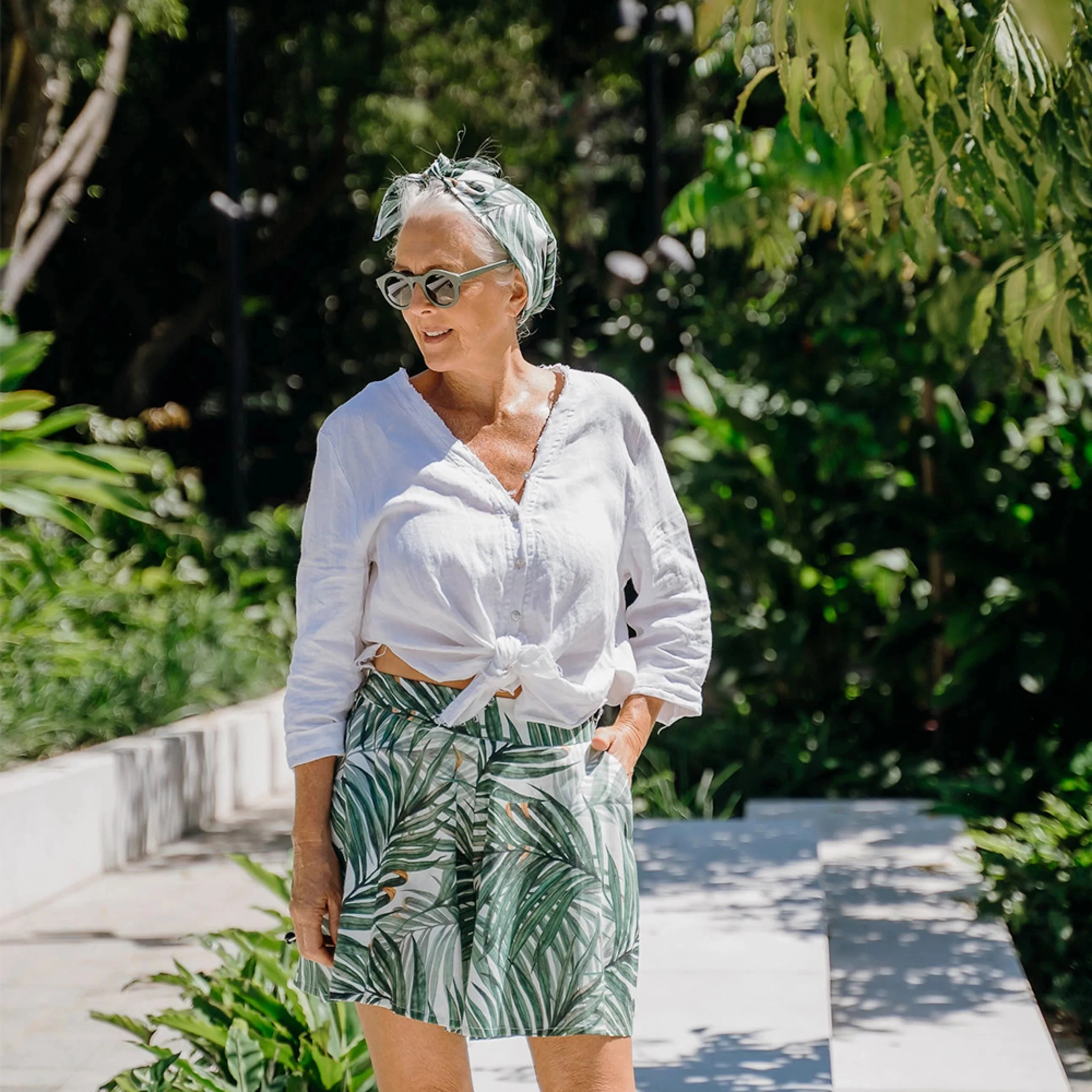 Woman wearing green palm leaf printed shorts