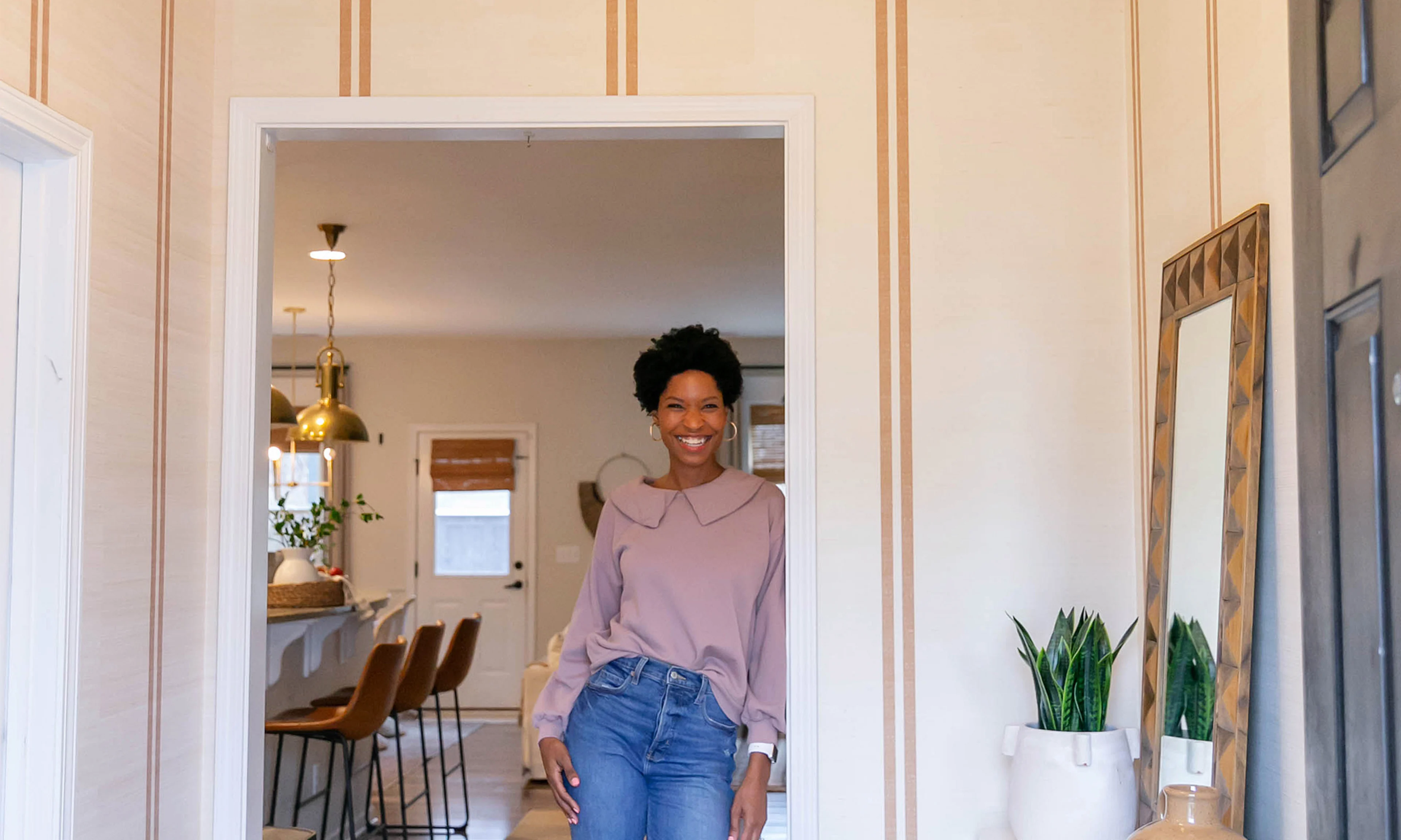Tiffany of the Prettyreal blog in her entryway redone with grasscloth wallpaper.