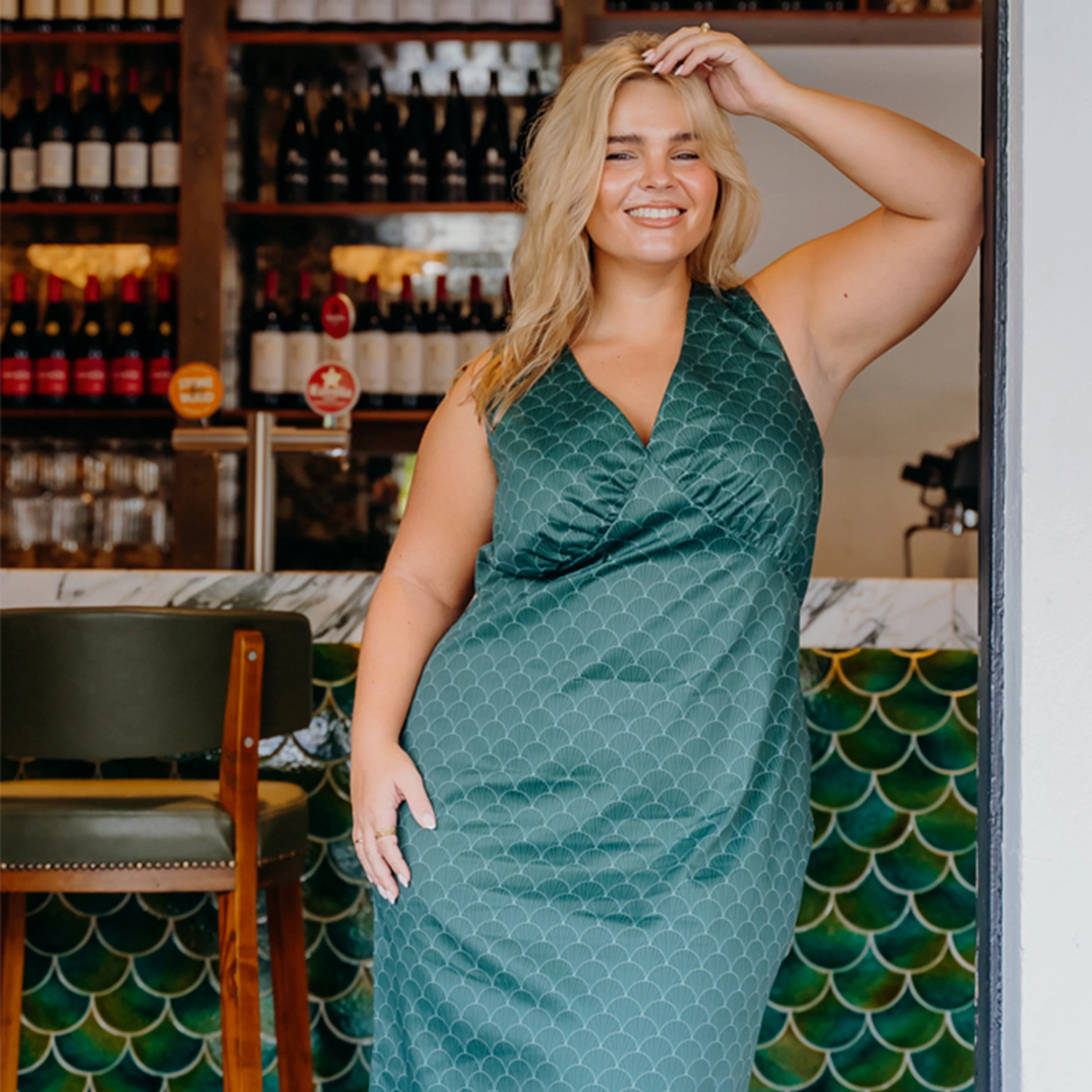Woman in a teal slip dress.