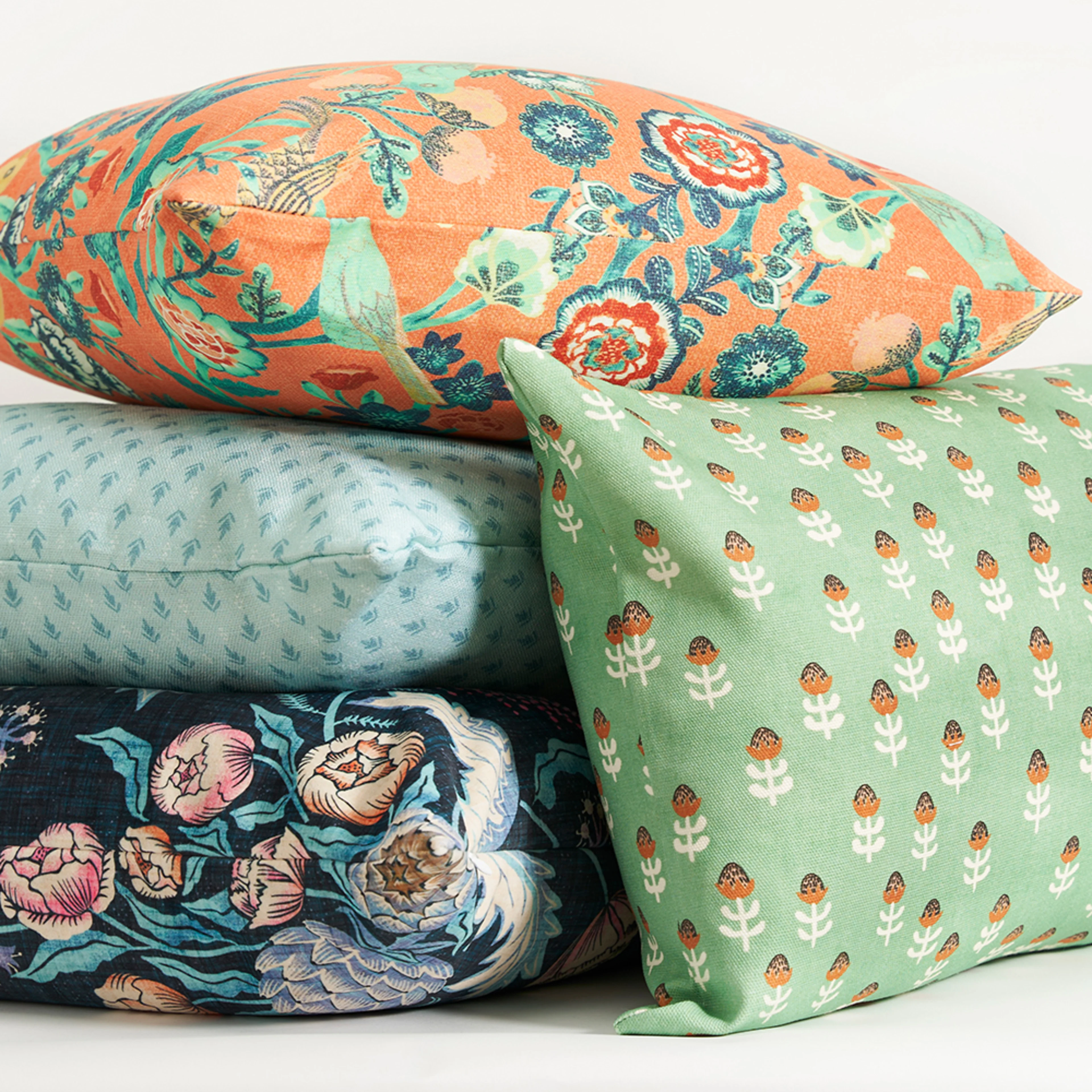 Square throw pillows on a white background.